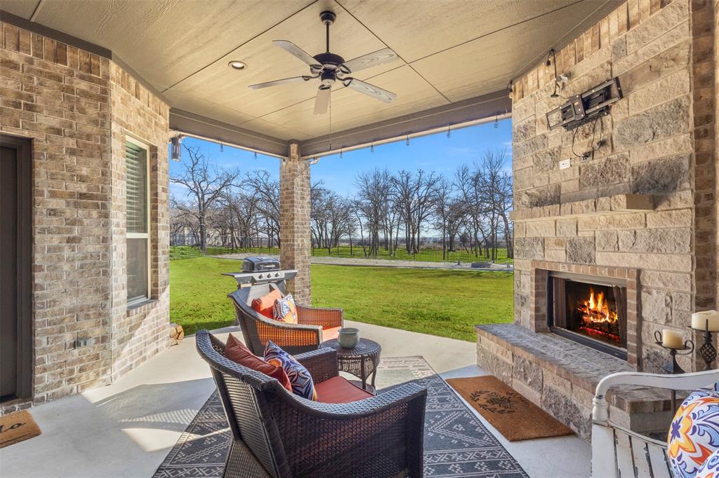 703 Winkler Way Springtown, TX 76082 - Photo 27 of 37 a outdoor space with patio fireplace furniture and garden