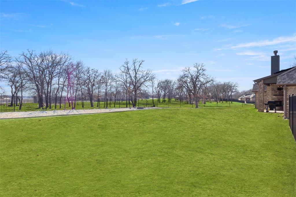 703 Winkler Way Springtown, TX 76082 - Photo 28 of 37 a view of field with tall trees