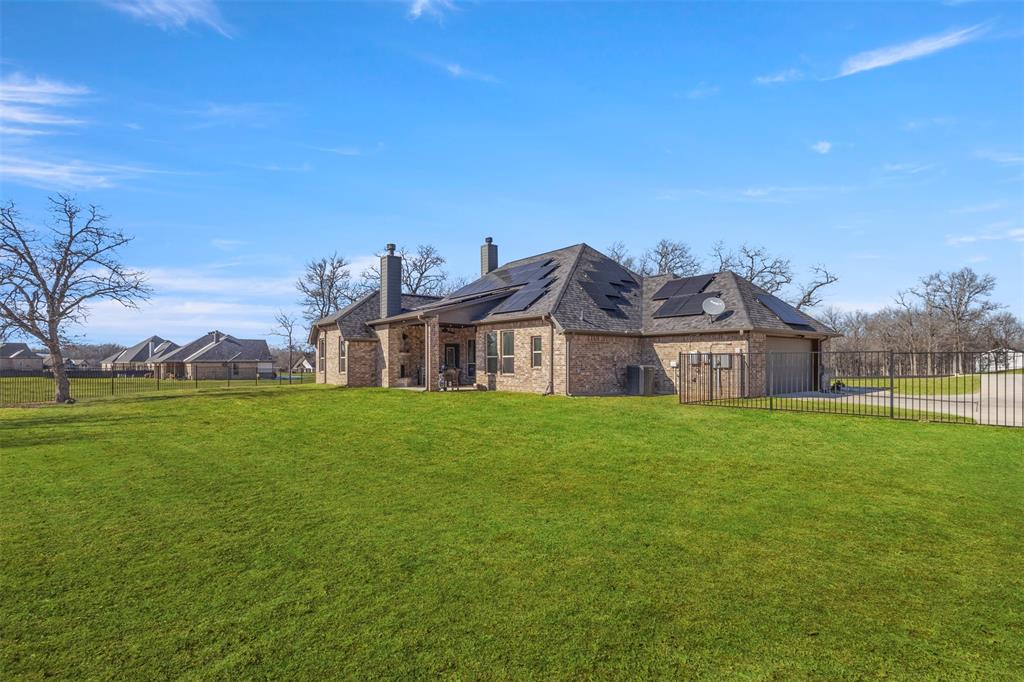 703 Winkler Way Springtown, TX 76082 - Photo 29 of 37 a front view of a house with a garden
