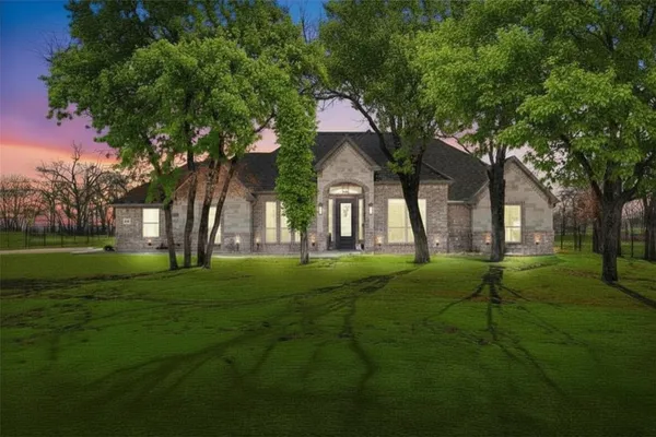 a backyard of a house with lots of green space and fountain