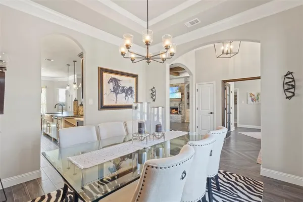 a living room with furniture a table and a chandelier