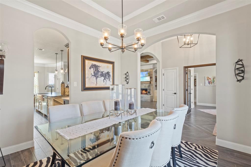 703 Winkler Way Springtown, TX 76082 - Photo 8 of 37 a living room with furniture a table and a chandelier