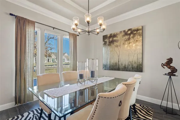 a living room with furniture a table and a chandelier