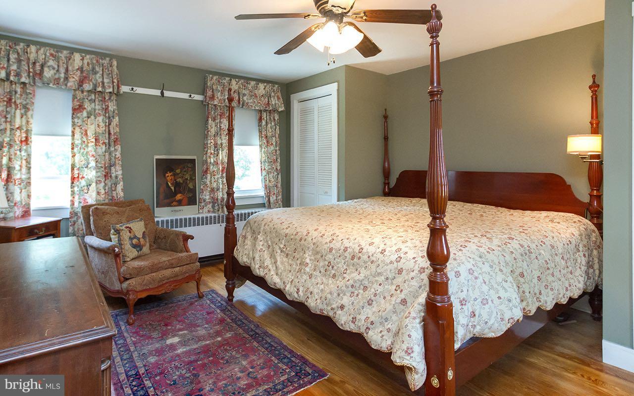 1004 Freeland Road Freeland, MD 21053 - Photo 17 of 30 a bedroom with a bed couch and a fireplace
