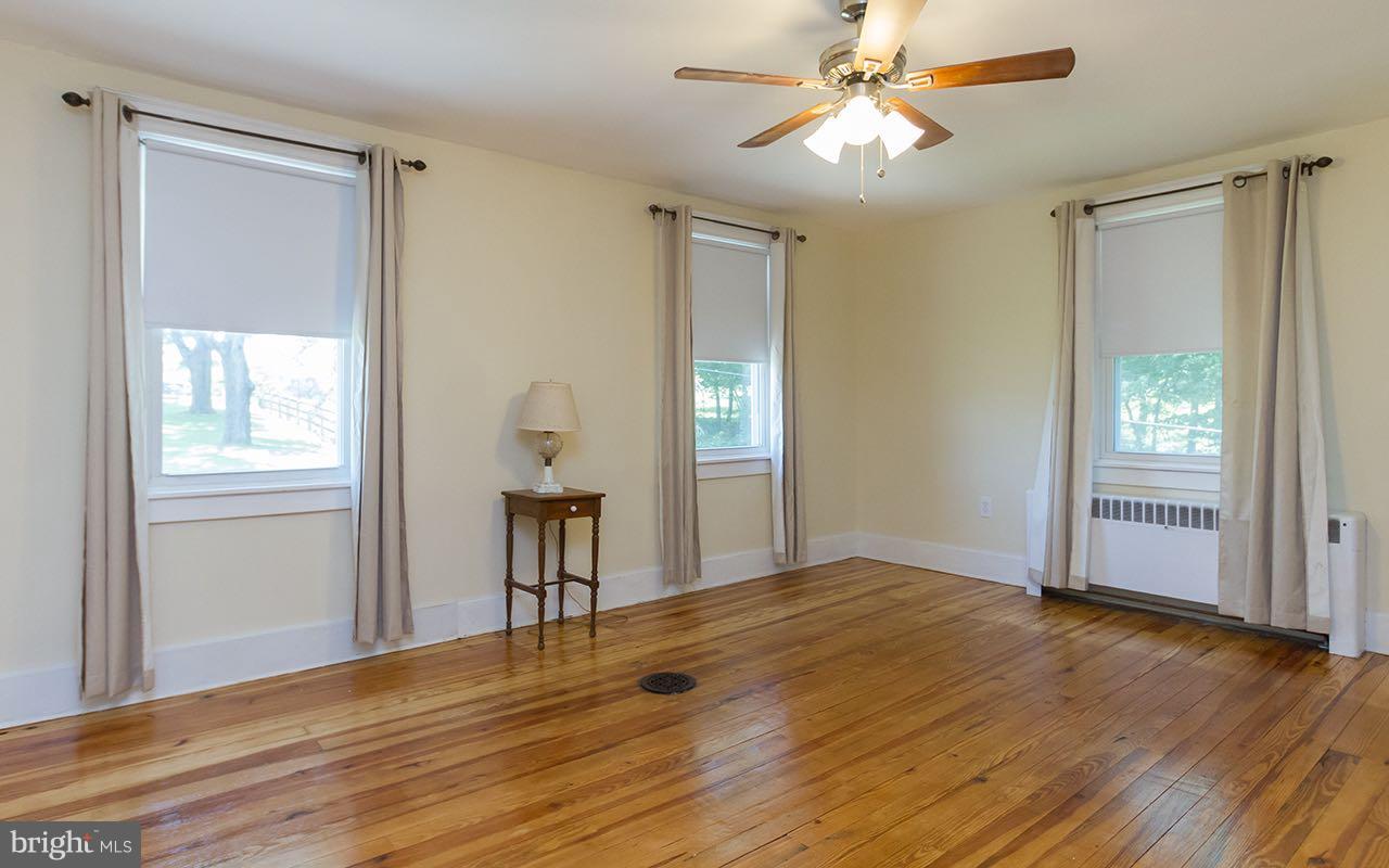 1004 Freeland Road Freeland, MD 21053 - Photo 20 of 30 a view of empty room with wooden floor and fan