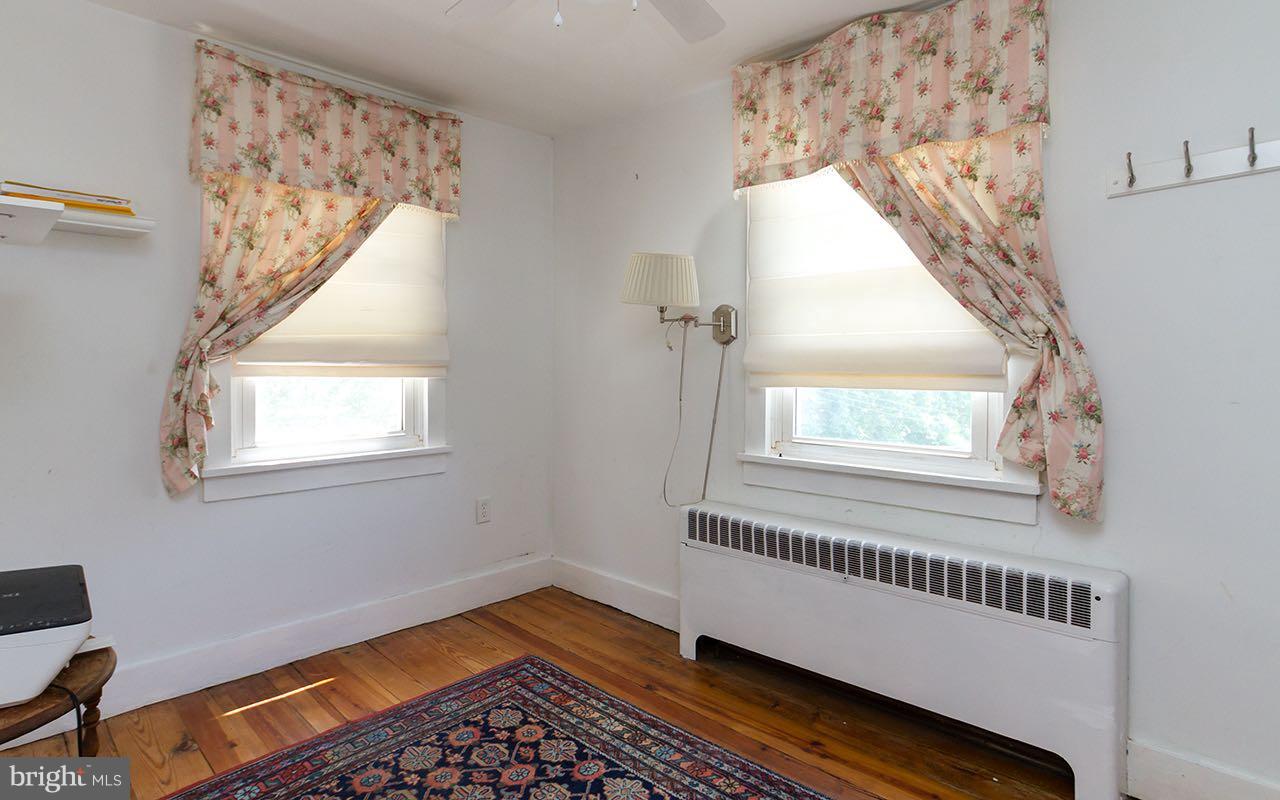 1004 Freeland Road Freeland, MD 21053 - Photo 22 of 30 a view of an empty room with wooden floor and a window