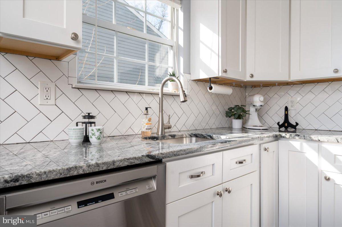 7804 East A E Shore Road Pasadena, MD 21122 - Photo 13 of 34 a kitchen with granite countertop white cabinets and white appliances