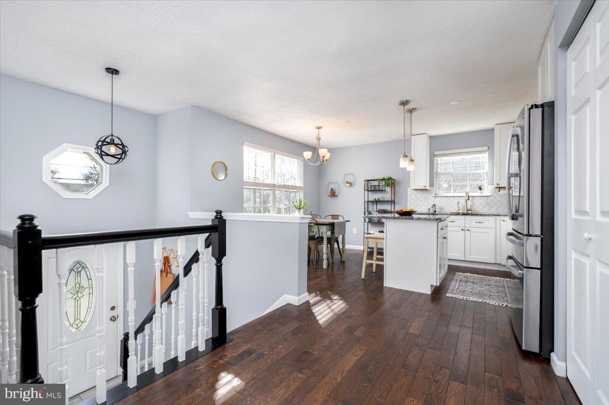 7804 East A E Shore Road Pasadena, MD 21122 - Photo 8 of 34 a view of a kitchen with furniture and wooden floor