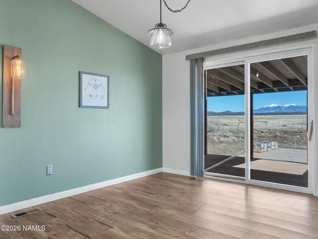 a view of a room with wooden floor