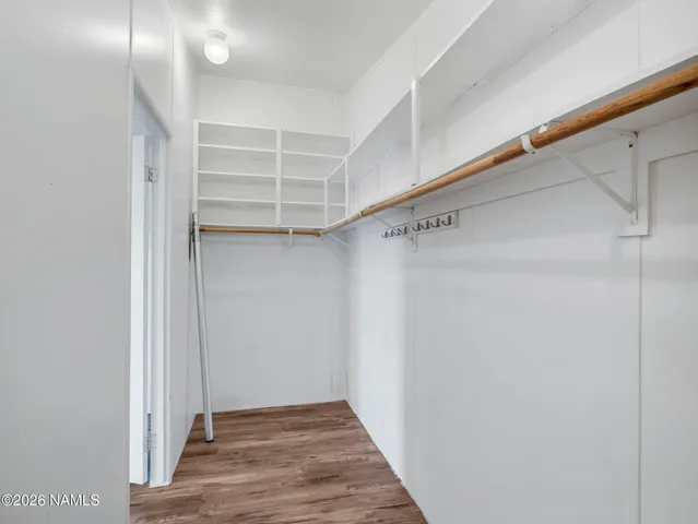 a view of walk in closet with empty racks