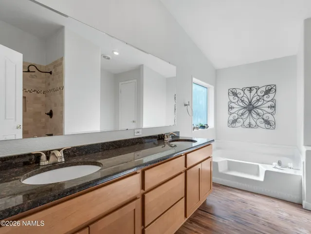 a bathroom with a granite countertop sink a mirror a and a