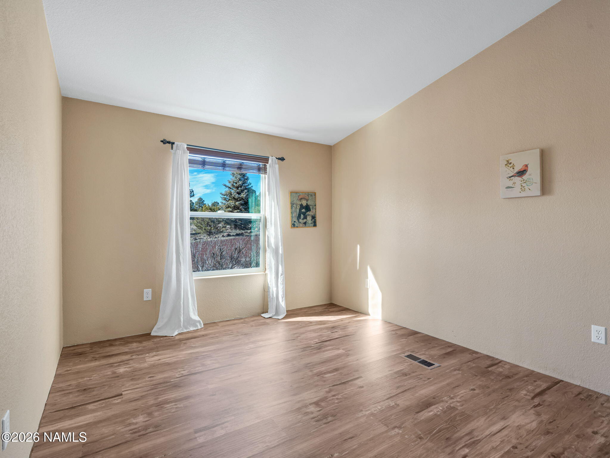 3095 North Peak View Road Williams, AZ 86046 - Photo 17 of 37 an empty room with wooden floor and windows
