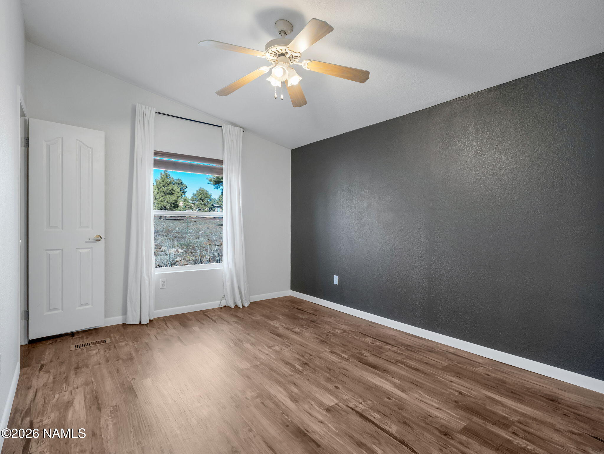 3095 North Peak View Road Williams, AZ 86046 - Photo 20 of 37 a view of an empty room with a window