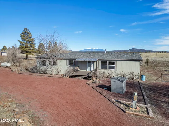 a front view of a house with sitting area