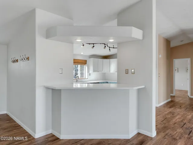a kitchen with stainless steel appliances a sink stove and cabinets