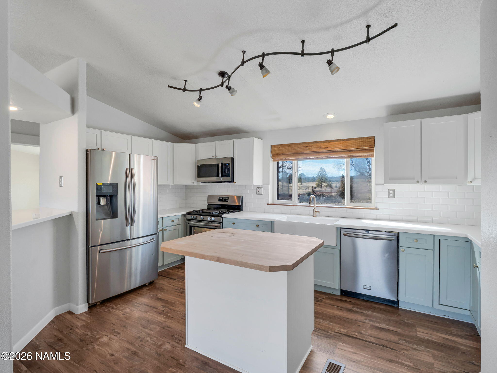 3095 North Peak View Road Williams, AZ 86046 - Photo 8 of 37 a kitchen with stainless steel appliances a sink a stove a refrigerator cabinets and a center island