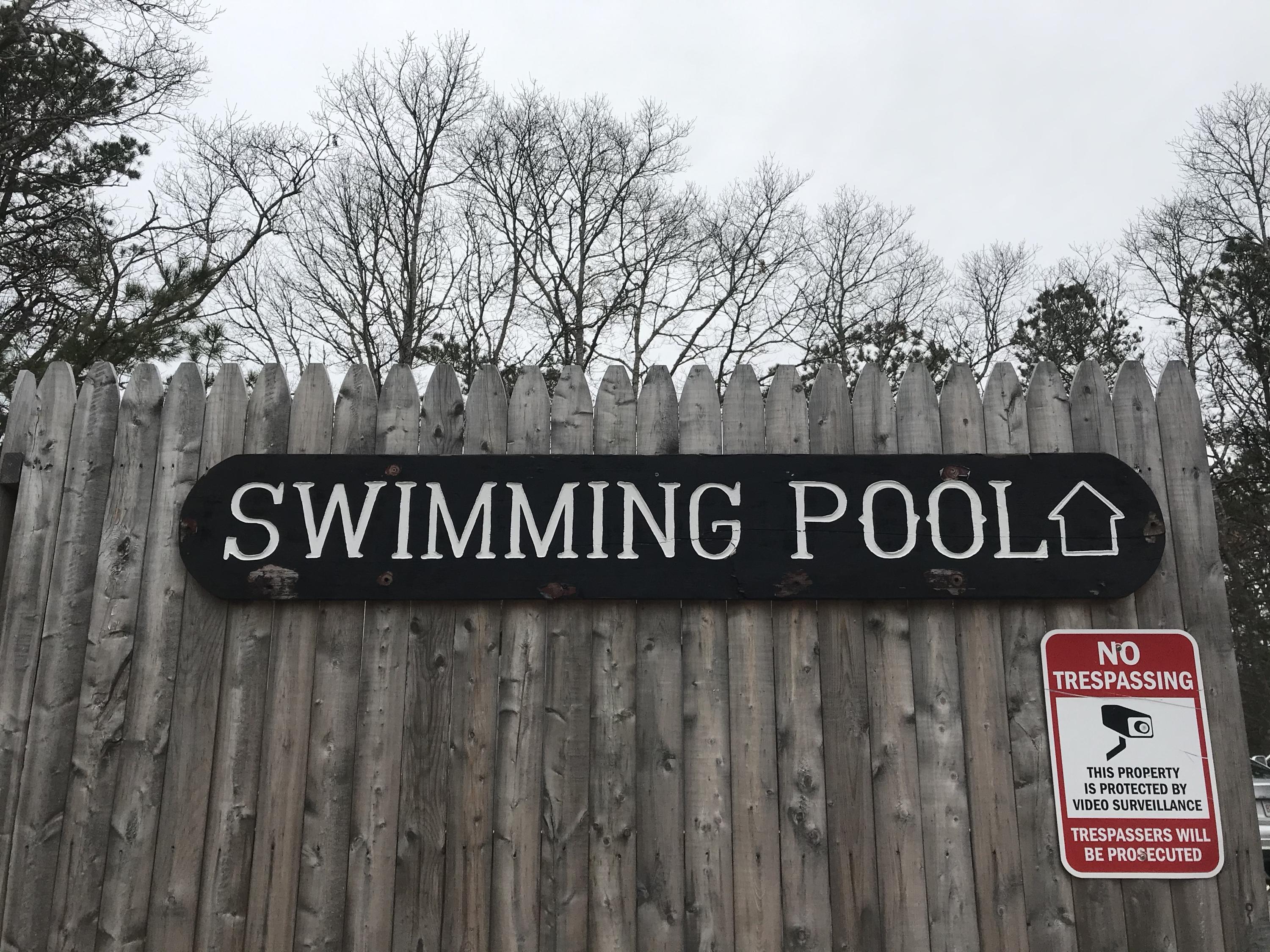 19 Round House Road, Unit 19 Bourne, MA 02532 - Photo 54 of 58 a street sign that is on a wooden wall