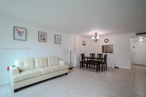 a living room with furniture and dining area