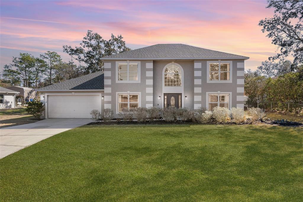 a front view of a house with a garden