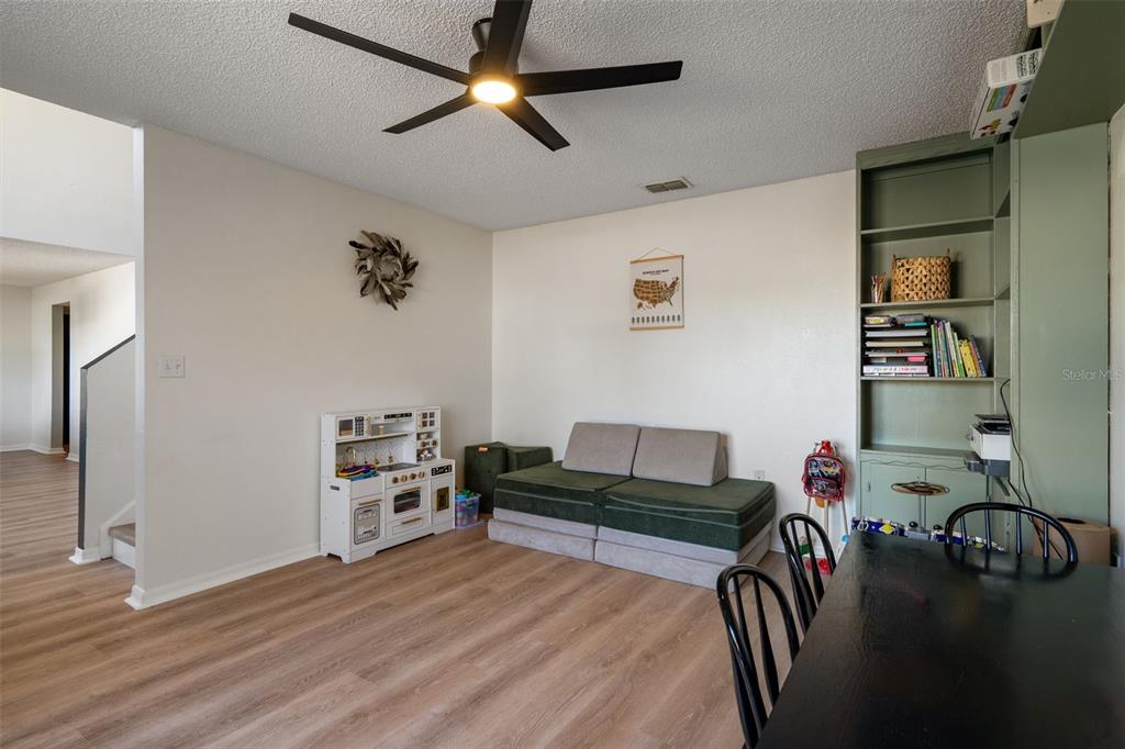 11258 Lomita Wren Road Weeki Wachee, FL 34614 - Photo 12 of 46 a living room with furniture and wooden floor