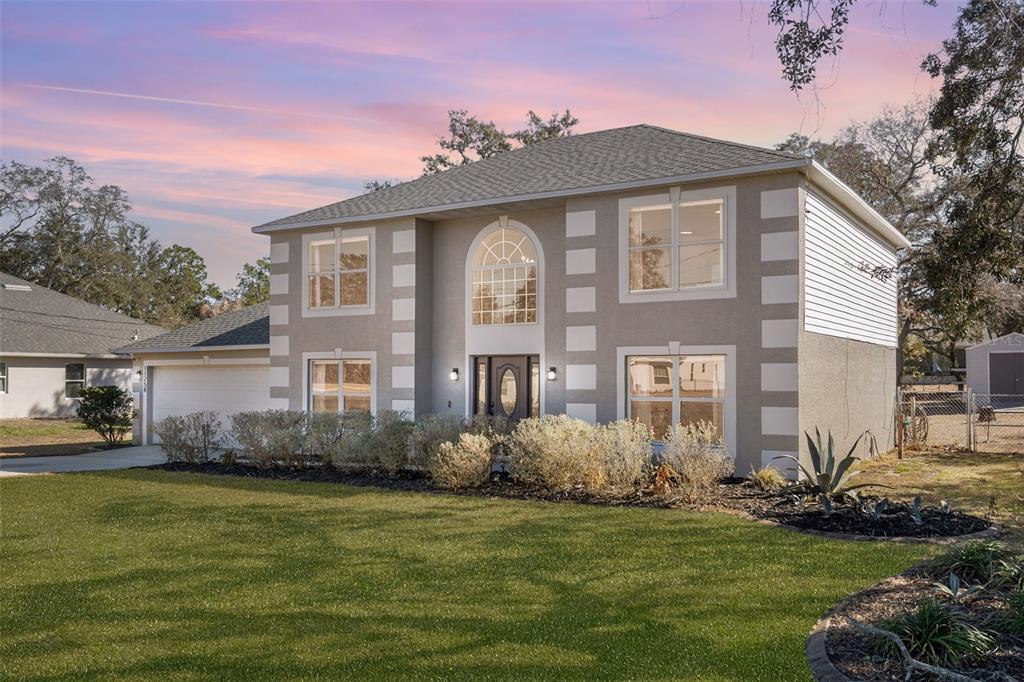 11258 Lomita Wren Road Weeki Wachee, FL 34614 - Photo 2 of 46 a front view of a house with a garden