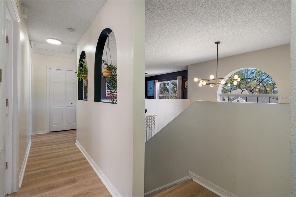 11258 Lomita Wren Road Weeki Wachee, FL 34614 - Photo 24 of 46 a view of a hallway with wooden floor and staircase