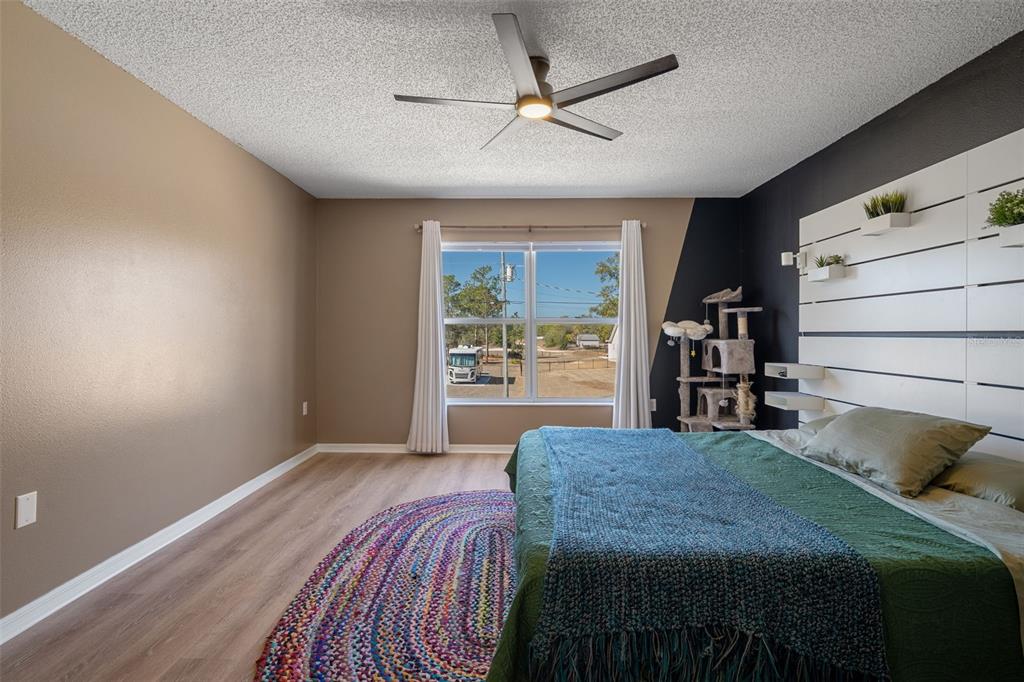 11258 Lomita Wren Road Weeki Wachee, FL 34614 - Photo 26 of 46 a bed sitting in a bedroom next to a window