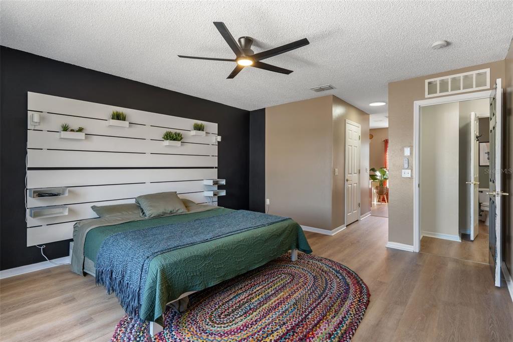 11258 Lomita Wren Road Weeki Wachee, FL 34614 - Photo 27 of 46 a bedroom with a bed and a ceiling fan