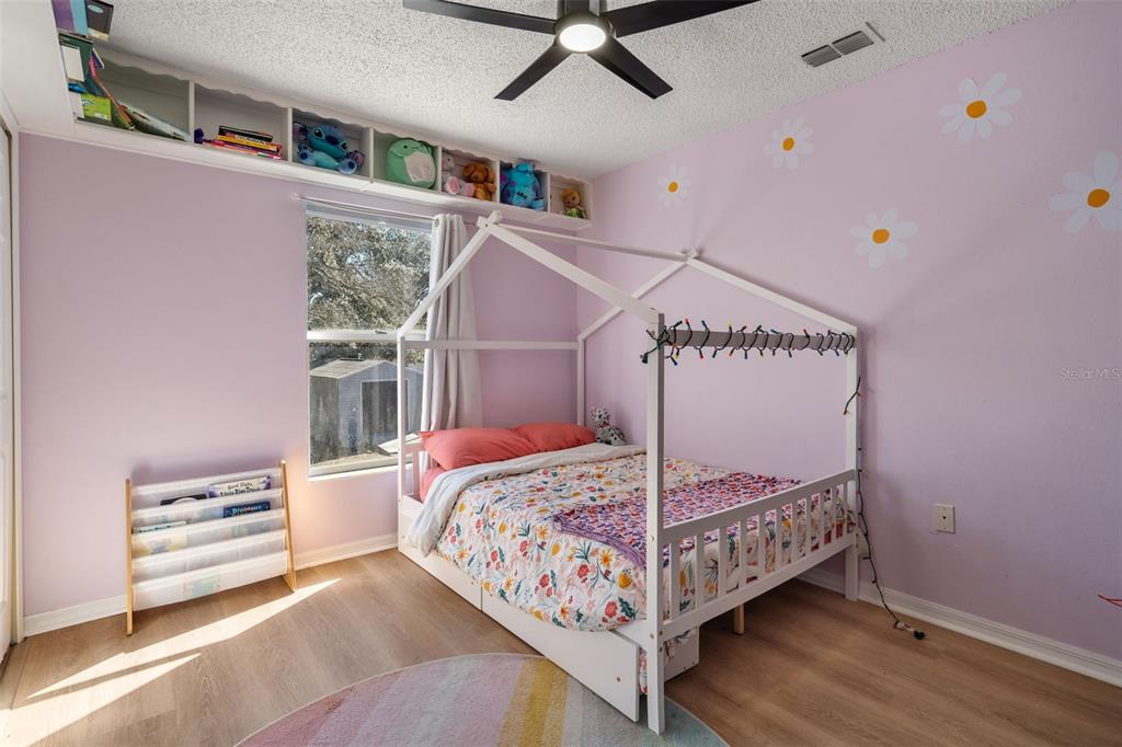 11258 Lomita Wren Road Weeki Wachee, FL 34614 - Photo 32 of 46 a bedroom with a bed and a window