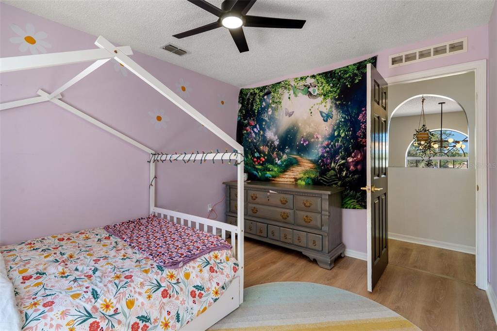 11258 Lomita Wren Road Weeki Wachee, FL 34614 - Photo 33 of 46 a bedroom with a bed and a painting on the wall