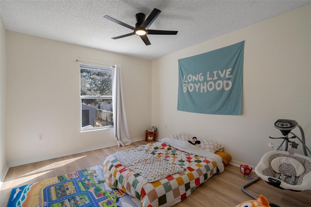 11258 Lomita Wren Road Weeki Wachee, FL 34614 - Photo 35 of 46 a bedroom with a bed and a window