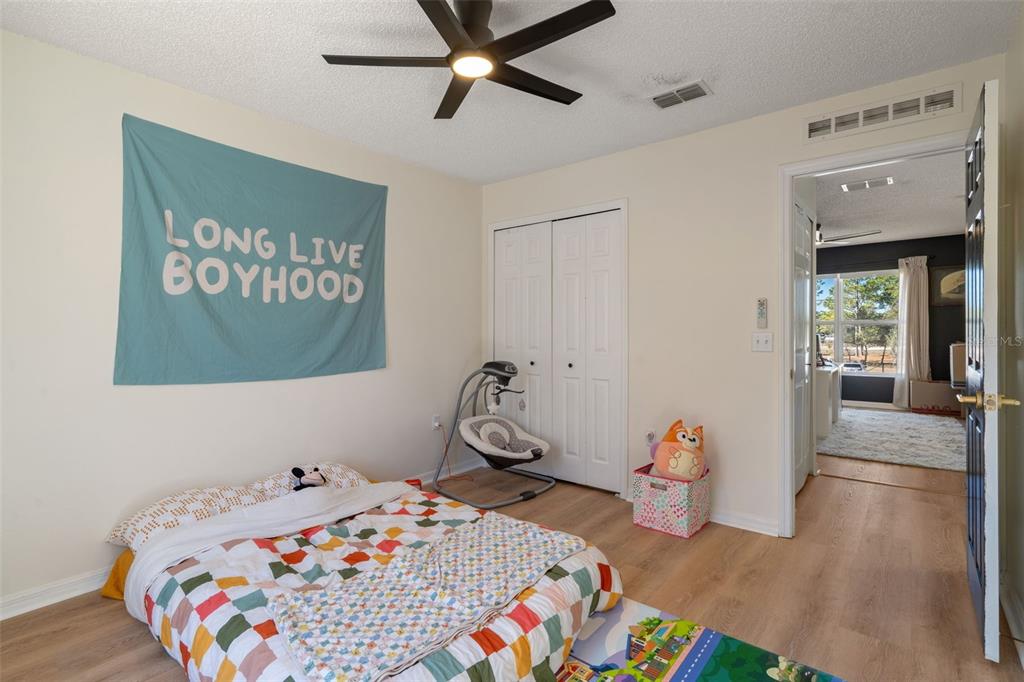 11258 Lomita Wren Road Weeki Wachee, FL 34614 - Photo 36 of 46 a bedroom with a bed and wooden floor