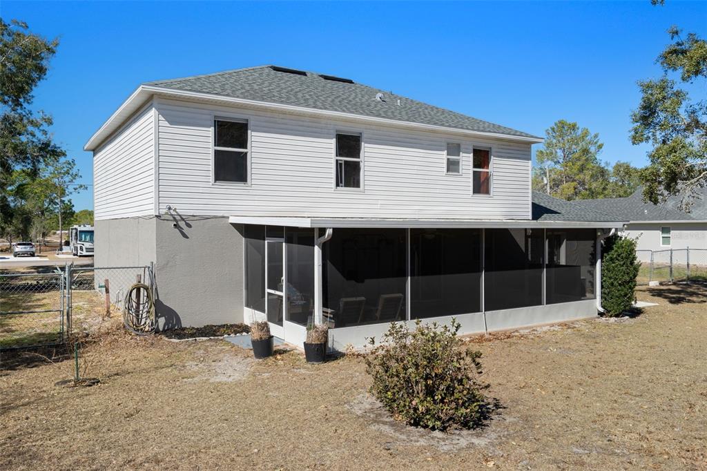 11258 Lomita Wren Road Weeki Wachee, FL 34614 - Photo 42 of 46 a front view of a house with a yard and garage