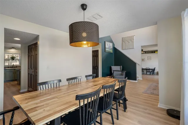 a dining room with furniture and wooden floor
