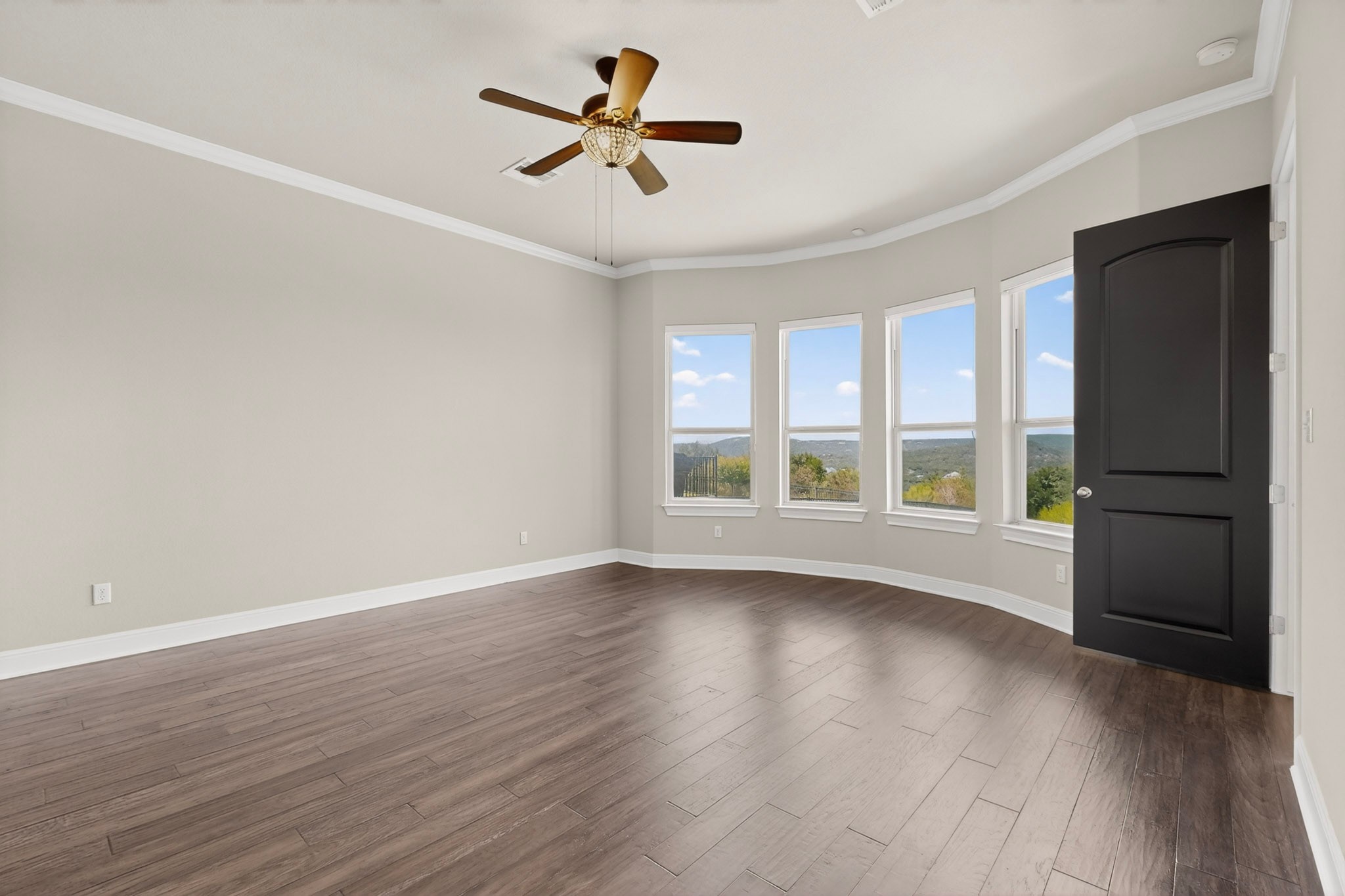 2617 Milan Meadows Drive Leander, TX 78641 - Photo 10 of 40 Hardwood floors and generous windows create an inviting, naturally illuminated primary bedroom retreat with expansive views.