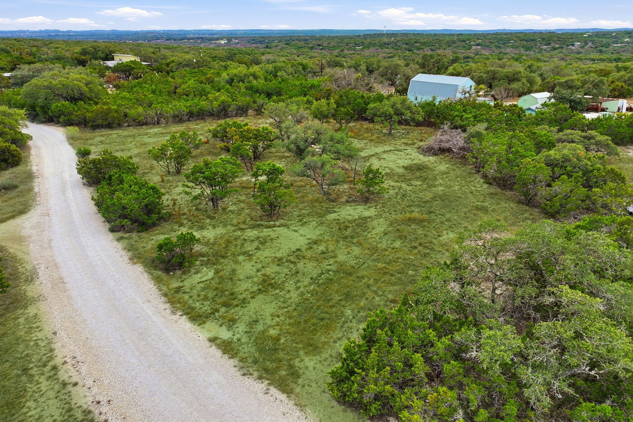 740 Hillcrest Trail Spring Branch, TX 78070 - Photo 17 of 30 a view of a green field with lots of bushes