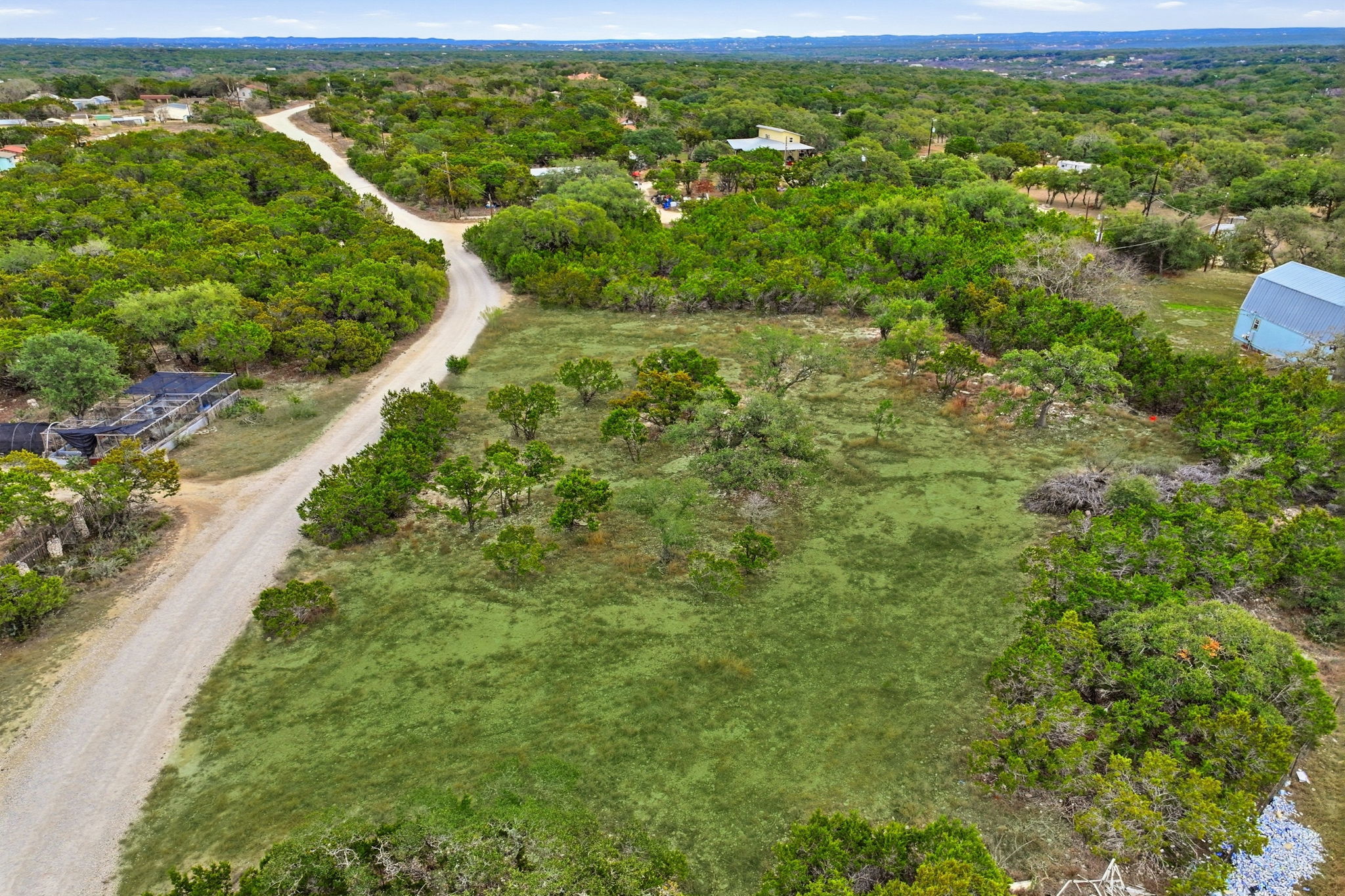 740 Hillcrest Trail Spring Branch, TX 78070 - Photo 27 of 27 a view of a green field with lots of bushes