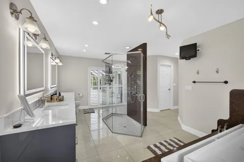 a large white kitchen with a large window