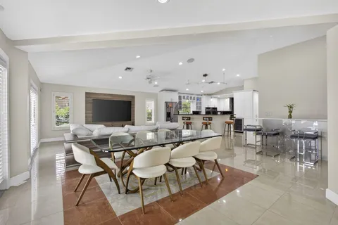 a kitchen with stainless steel appliances kitchen island granite countertop a stove sink and cabinets