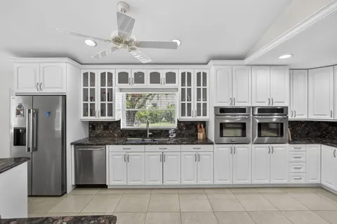 a kitchen with counter top space cabinets and stainless steel appliances