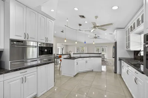 a kitchen with a sink a stove and cabinets
