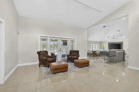 a living room with furniture and large windows