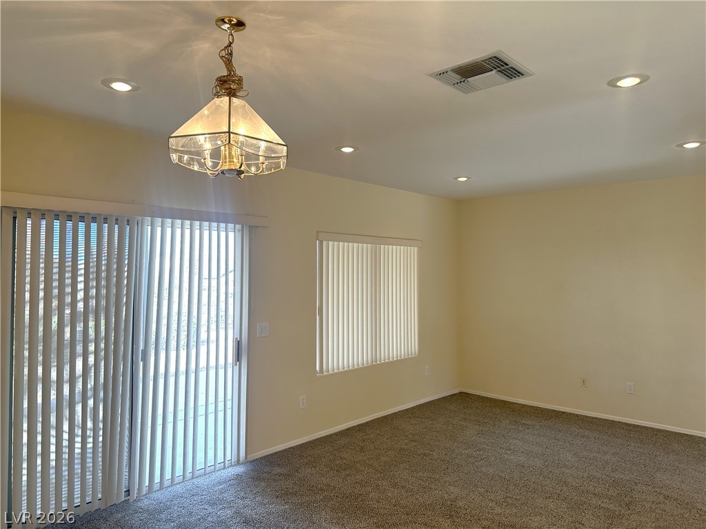 3034 Canal Walk Road Henderson, NV 89052 - Photo 21 of 24 This inviting room features soft carpet and bright windows, creating a versatile living space.