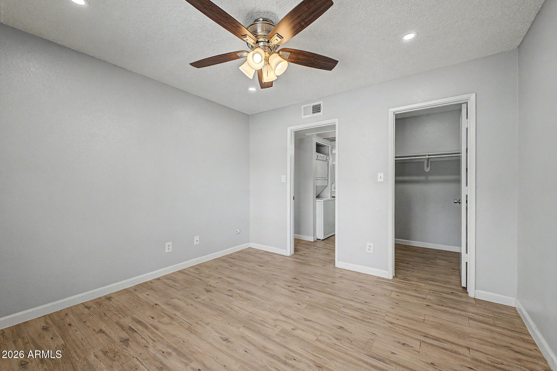 2625 East Indian School Road, Unit 227 Phoenix, AZ 85016 - Photo 15 of 31 an empty room with closet and a ceiling fan