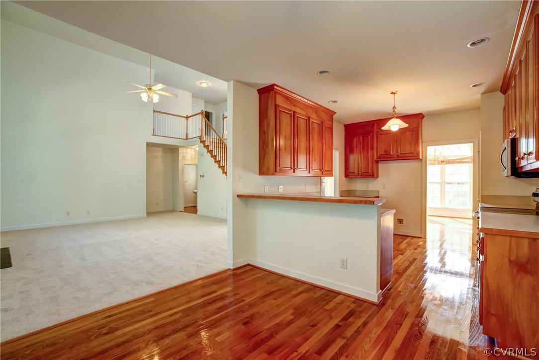 858 Club Ridge Terrace Chester, VA 23836 - Photo 8 of 29 a view of a kitchen with wooden floor and a ceiling fan