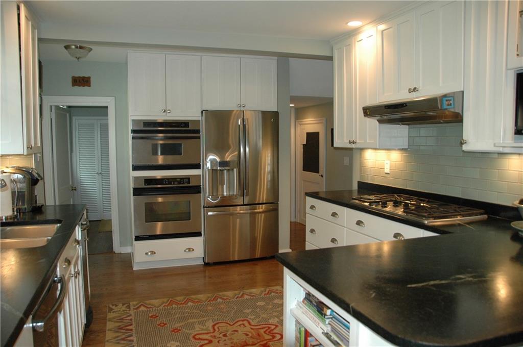 303 Pine Road Edgeworth, PA 15143 - Photo 7 of 24 Kitchen is open and functional - soapstone counters, tile backsplash, stainless appliances including new refrigerator. Two large pantry closets are steps away.