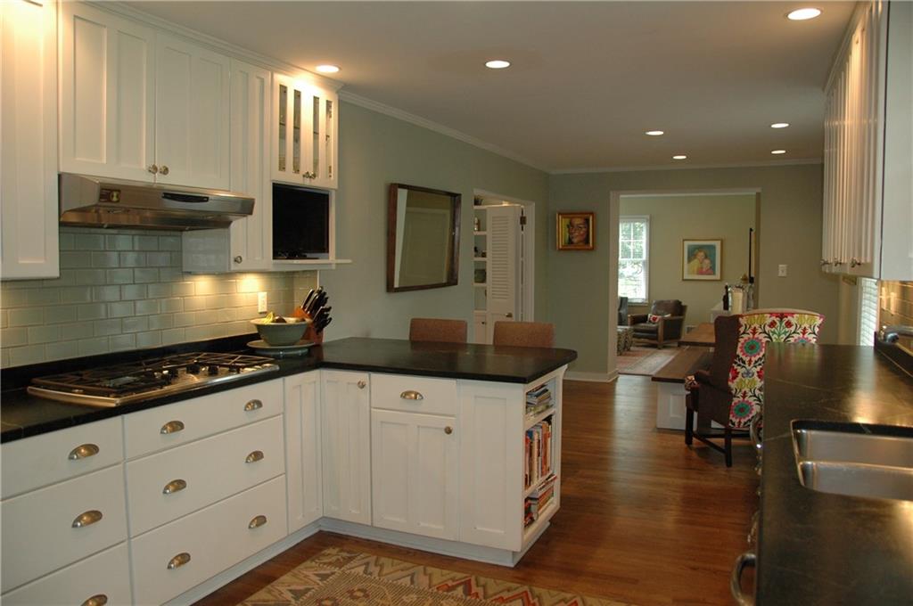 303 Pine Road Edgeworth, PA 15143 - Photo 8 of 24 a kitchen that has a lot of cabinets in it and wooden floors