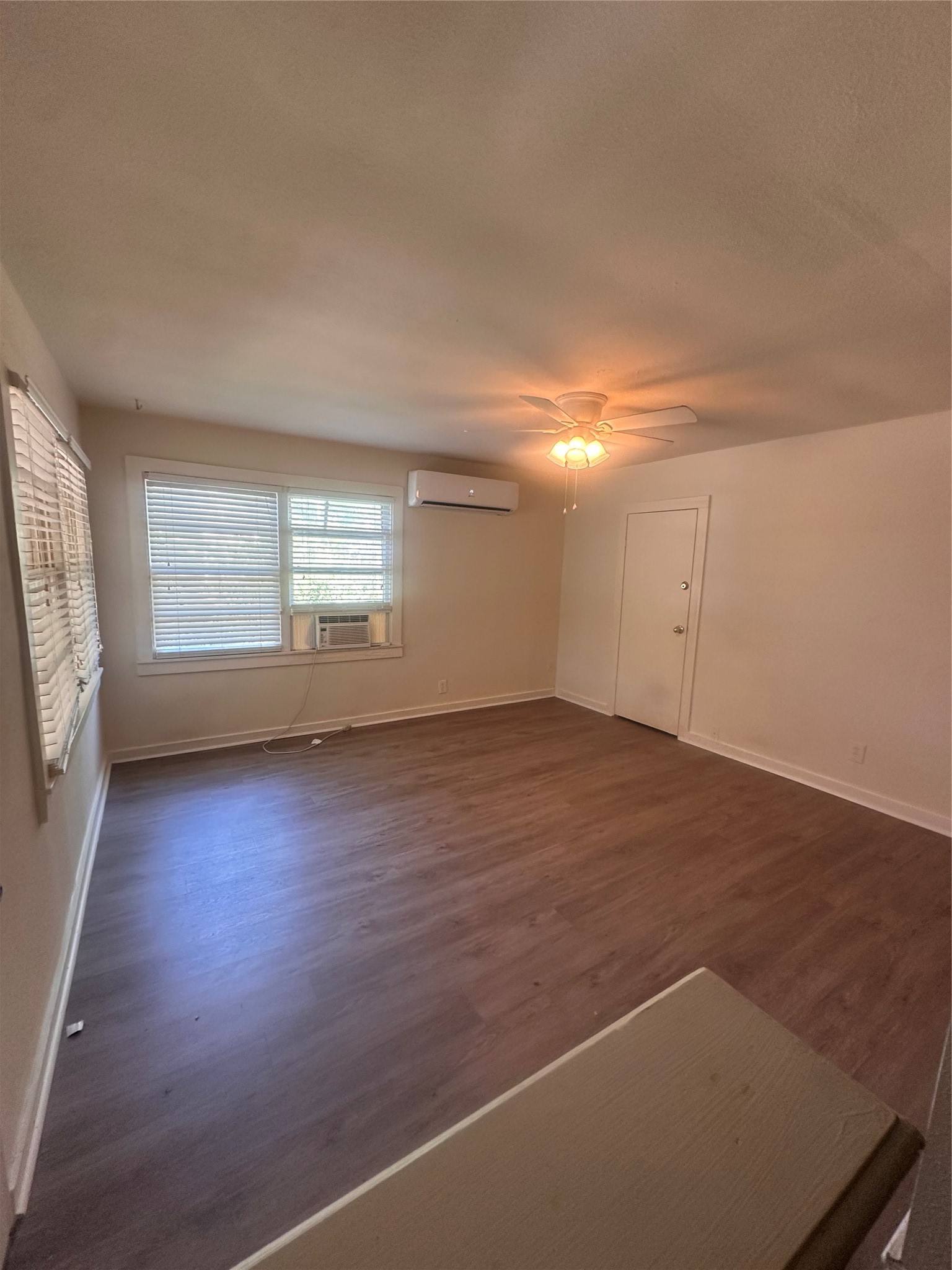 1607 Klauke Street Rosenberg, TX 77471 - Photo 3 of 17 an empty room with wooden floor and windows