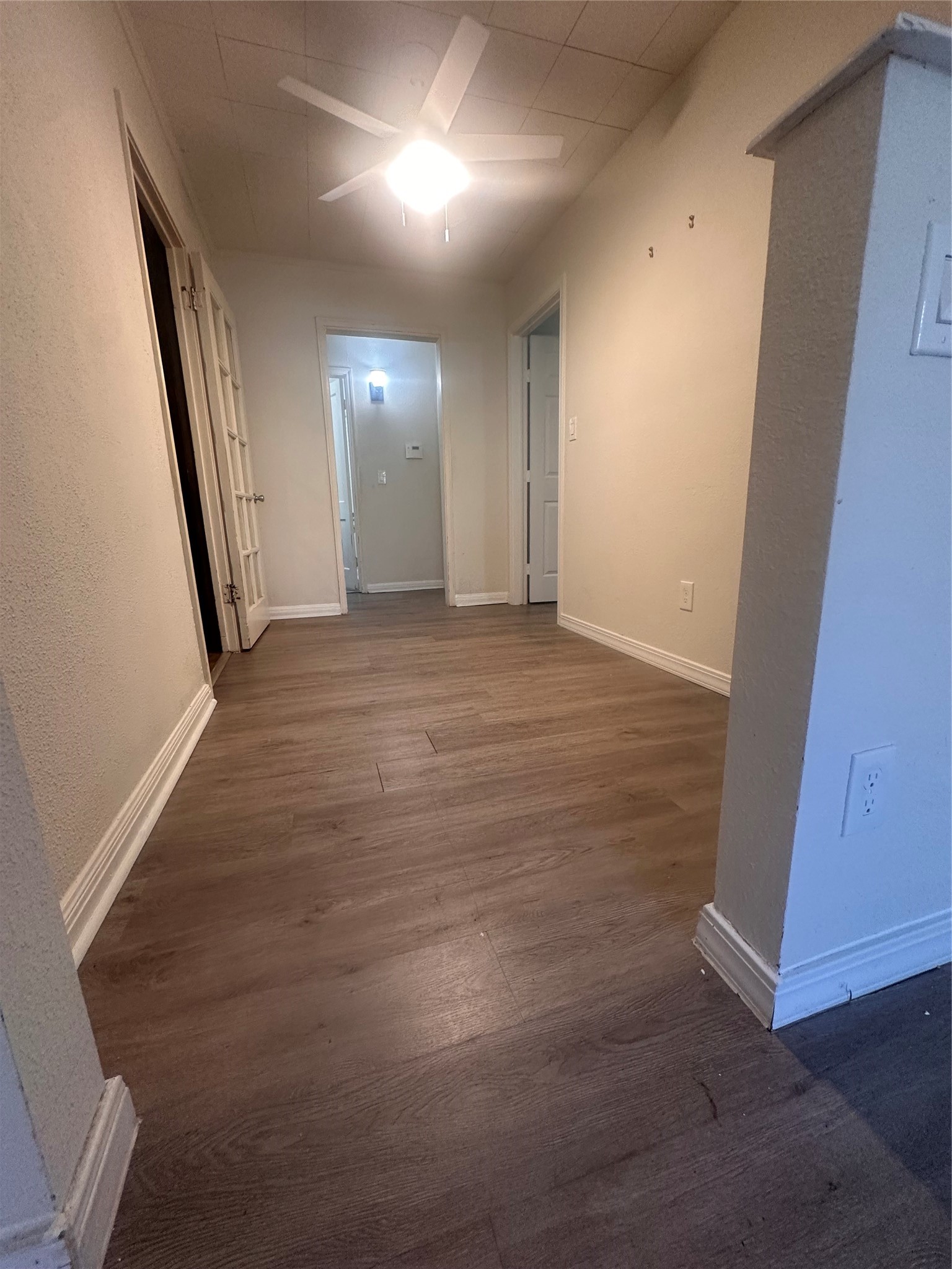1607 Klauke Street Rosenberg, TX 77471 - Photo 4 of 17 an empty room with wooden floor and windows
