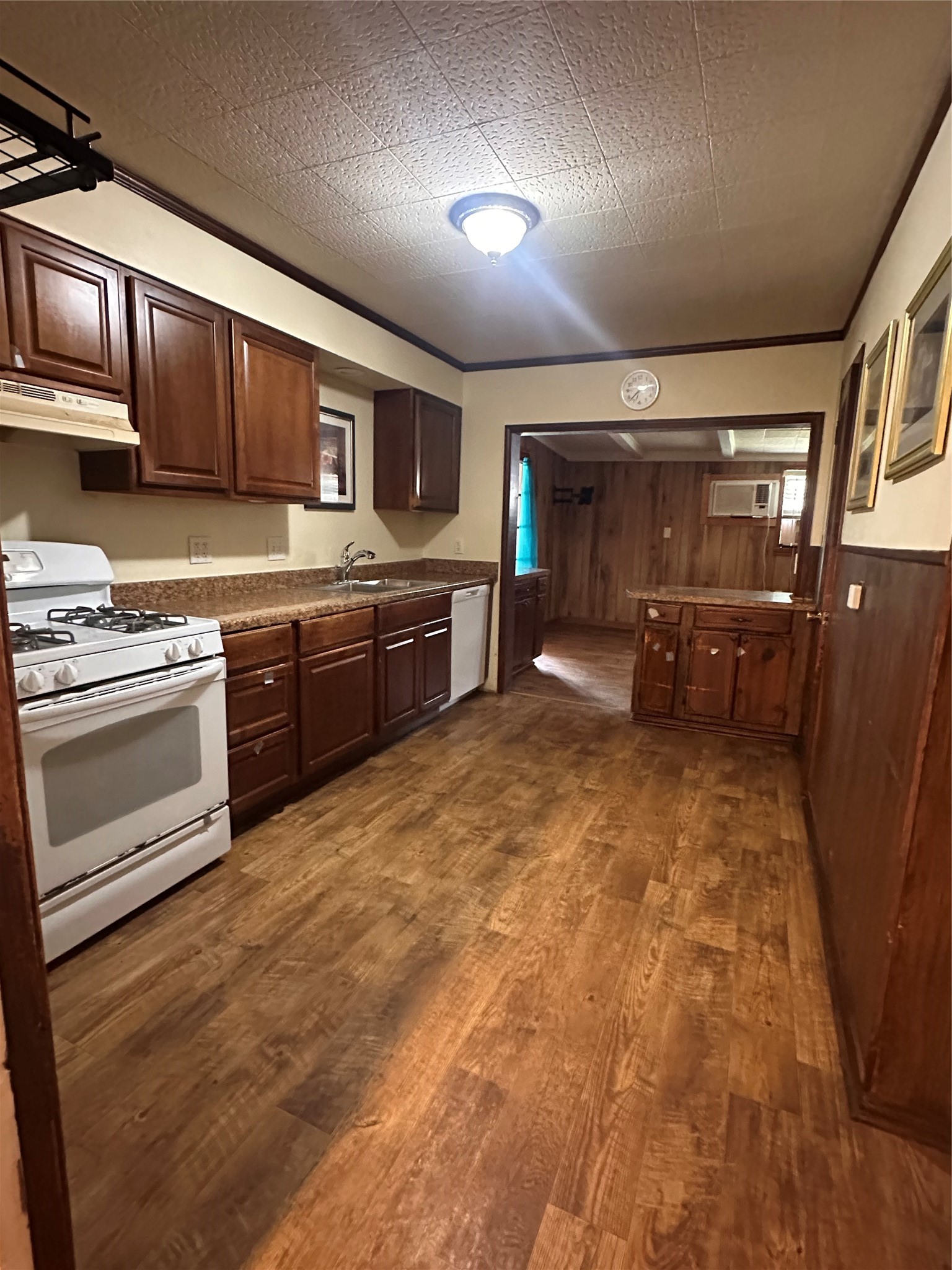 1607 Klauke Street Rosenberg, TX 77471 - Photo 5 of 17 a kitchen with stainless steel appliances granite countertop a stove top oven a sink dishwasher and a refrigerator with wooden cabinets